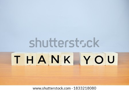 Wooden blocks with THANK YOU lettering on blurred background with copy space. 
