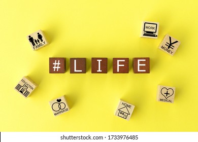 Wooden Blocks With Various Life Events On Yellow Background