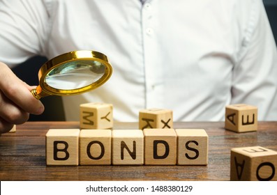 Wooden blocks with the word Bonds and businessman. A bond is a security that indicates that the investor has provided a loan to the issuer. Equivalent loan. Unsecured and secured bonds.