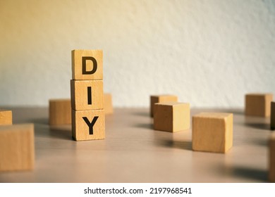 Wooden Blocks With The Word DIY - Do It Yourself Concept. The Method Of Self-creation Of Things Without The Help Of Professionals. Selective Focus