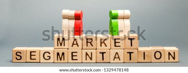 Wooden blocks with the word Market\
Segmentation and multicolored groups of people. Target audience,\
customer care. Market group of buyers. Customer analysis, customer\
relationship management.