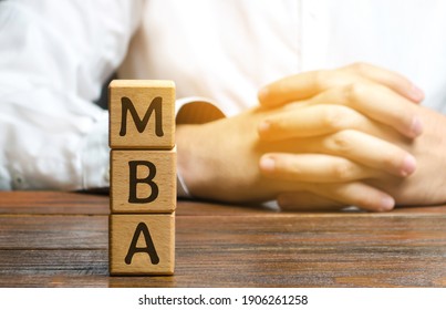 Wooden Blocks With The Word MBA - Master Of Business Administration. Degree Of Professionalism In Business Management. Accounting, Human Resources, Applied Statistics, Communication, Ethics