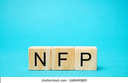 Wooden Blocks With The Word NFP. Nonfarm Payrolls - Key Economic Indicator. Natural Family Planning Concept