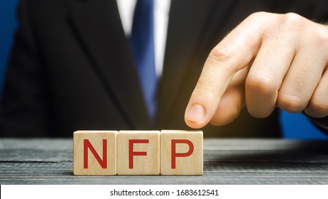 Wooden Blocks With The Word NFP. Nonfarm Payrolls - Key Economic Indicator. Natural Family Planning Concept