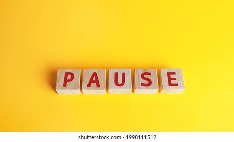 Wooden Blocks With The Word Pause. Break Time Concept. A Break During Work. Time To Relax And Recharge. Stop The Business Process