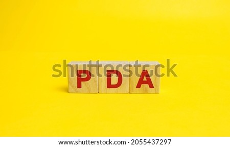 Wooden blocks with the word PDA. Personal Digital Assistant acronym concept. Technology, business and finance