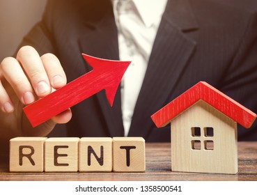 Wooden Blocks With The Word Rent, House And Up Arrow. The Concept Of The High Cost Of Rent For An Apartment Or Home. Interest Rates Are Rising. Real Estate Market. Increased Demand For Rental Property