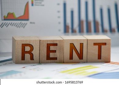 Wooden Blocks With The Word Rent, House And Up Arrow. The Concept Of The High Cost Of Rent For An Apartment Or Home. Interest Rates Are Rising. Real Estate Market. Increased Demand For Rental Property