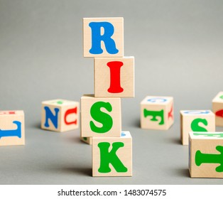 Wooden Blocks With The Word Risk And Randomly Scattered Cubes. Management, Cost Assessment, Business And Investment Safety. Strengthen Business Resilience And Flexibility. Risks Insurance