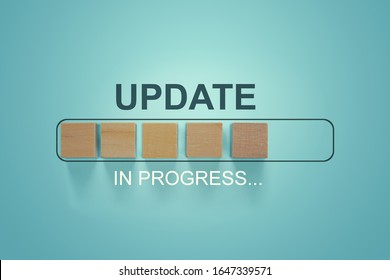 Wooden Blocks With The Word UPDATE  In Loading Bar Progress.
Business Concept For Act Updating Something Someone Or Updated Version Program.