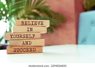 Wooden blocks with words 'Believe in yourself and succeed'. - Shutterstock ID 2294026835