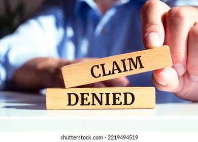 Wooden blocks with words 'Claim denied'. - Shutterstock ID 2219494519