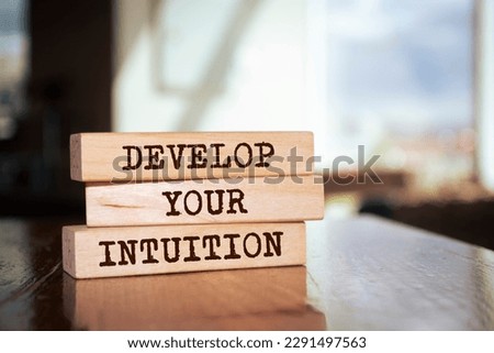 Wooden blocks with words 'DEVELOP YOUR INTUITION'.