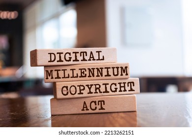 Wooden blocks with words 'Digital Millennium Copyright Act'. - DMCA - Shutterstock ID 2213262151