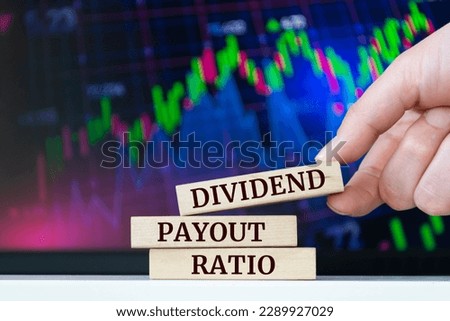 Wooden blocks with words 'DIVIDEND PAYOUT RATIO'. Business concept
