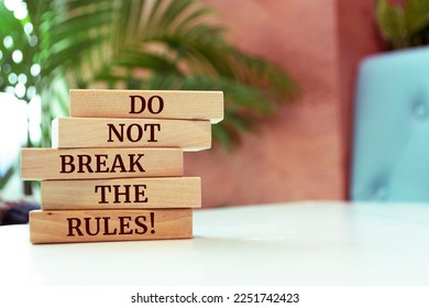 Wooden blocks with words 'Do not break the rules!'.