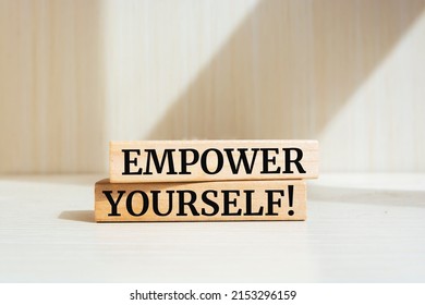 Wooden blocks with words 'Empower yourself'.
