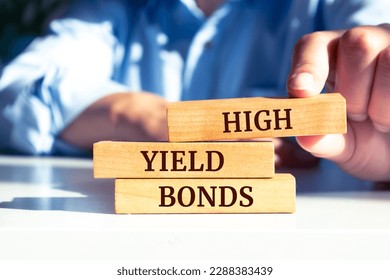 Wooden blocks with words 'High yield bonds'. Business concept