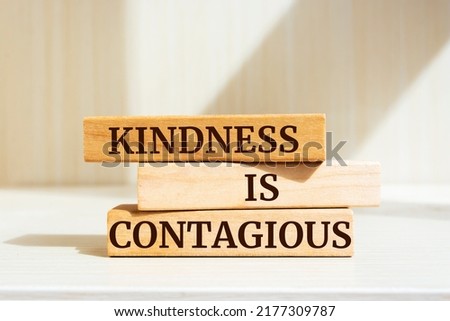 Wooden blocks with words 'Kindness is contagious'.
