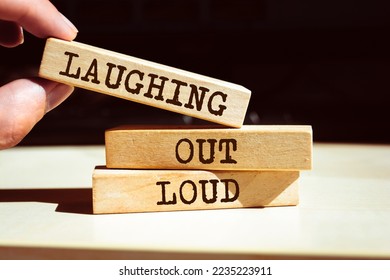 Wooden blocks with words 'Laughing Out Loud'. LOL - Shutterstock ID 2235223911