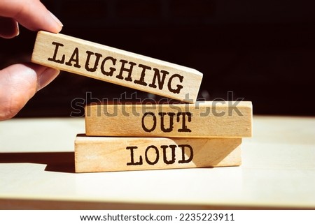 Wooden blocks with words 'Laughing Out Loud'. LOL