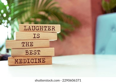 Wooden blocks with words 'Laughter is the best medicine'.