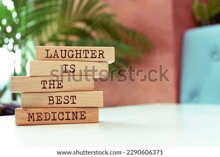 Wooden blocks with words 'Laughter is the best medicine'.