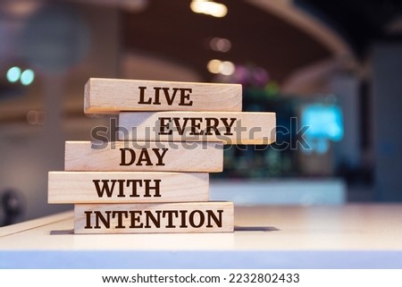 Wooden blocks with words 'Live every day with intention'.