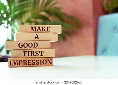 Wooden blocks with words 'Make a Good First Impression'.
