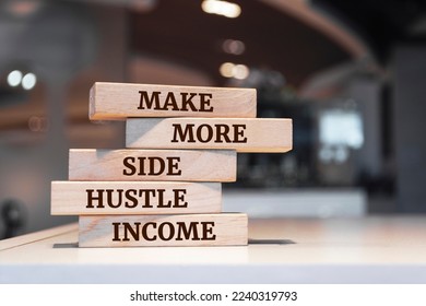 Wooden blocks with words 'Make more side hustle income'.