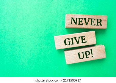 Wooden blocks and words 'NEVER GIVE UP' 
