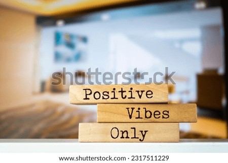 Wooden blocks with words 'Positive Vibes Only'.