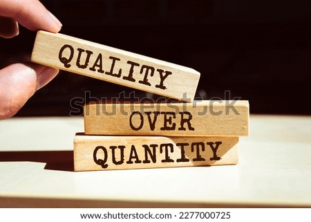 Wooden blocks with words 'Quality over quantity'.