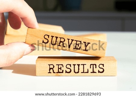 Wooden blocks with words 'SURVEY RESULTS'.