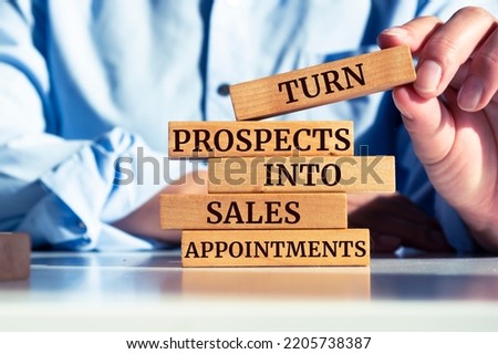 Wooden blocks with words 'Turn Prospects Into Sales Appointments'.