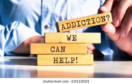 Wooden blocks and words 'Addiction? We can help' 