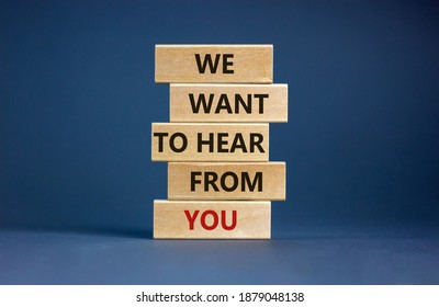 Wooden blocks with words 'we want to hear from you'. Beautiful grey background. Copy space. Business concept.