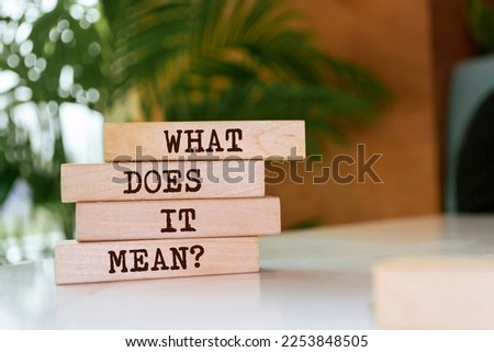 Wooden blocks with words 'What does it mean?'.