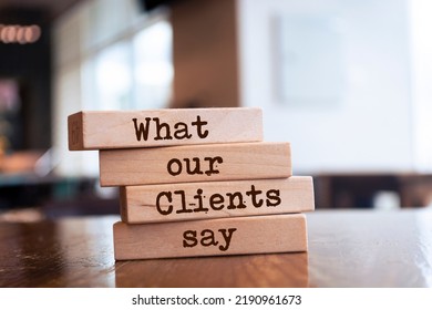 Wooden Blocks With Words 'What Our Clients Say'.