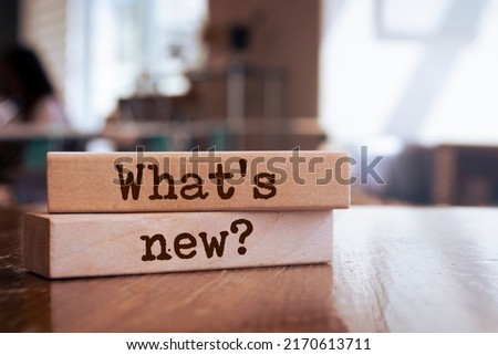 Wooden blocks with words 'What's new?'. Business concept
