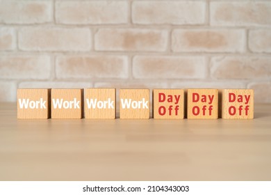 Wooden blocks with "Work" and "Day Off" text of concept.