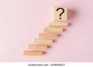 Wooden blokes as stairs and cube with question mark. Concept of Effective Goal Setting - Shutterstock ID 2198598157