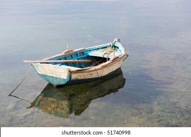 Wooden Blue Row Boat In Calm Water