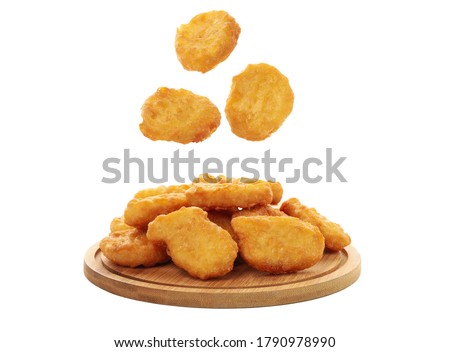 Wooden board with chicken nuggets isolated on white background