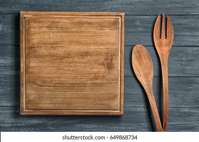 Wooden Board And Cooking Utensils On Table