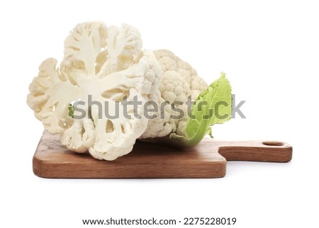 Wooden board with cut and whole cauliflowers on white background