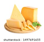Wooden board with different kinds of cheese and basil on white background
