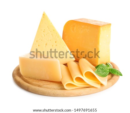Wooden board with different kinds of cheese and basil on white background
