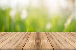 Empty wooden table with blurred green background with a country outdoor ...