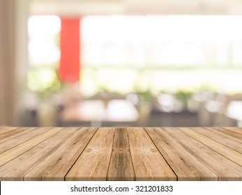 Wooden board empty table in front of blurred background. Perspective brown wood over blur in coffee shop - can be used for display or montage your products.Mock up your products.Vintage filter.